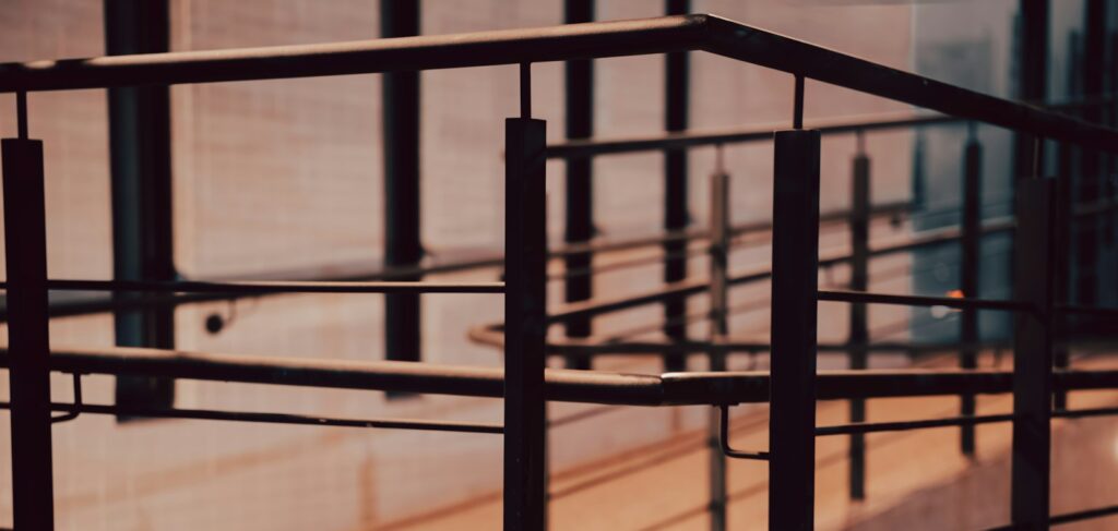 Black metal railings on a modern staircase, the kind of balustrade that benefits from regular cleaning