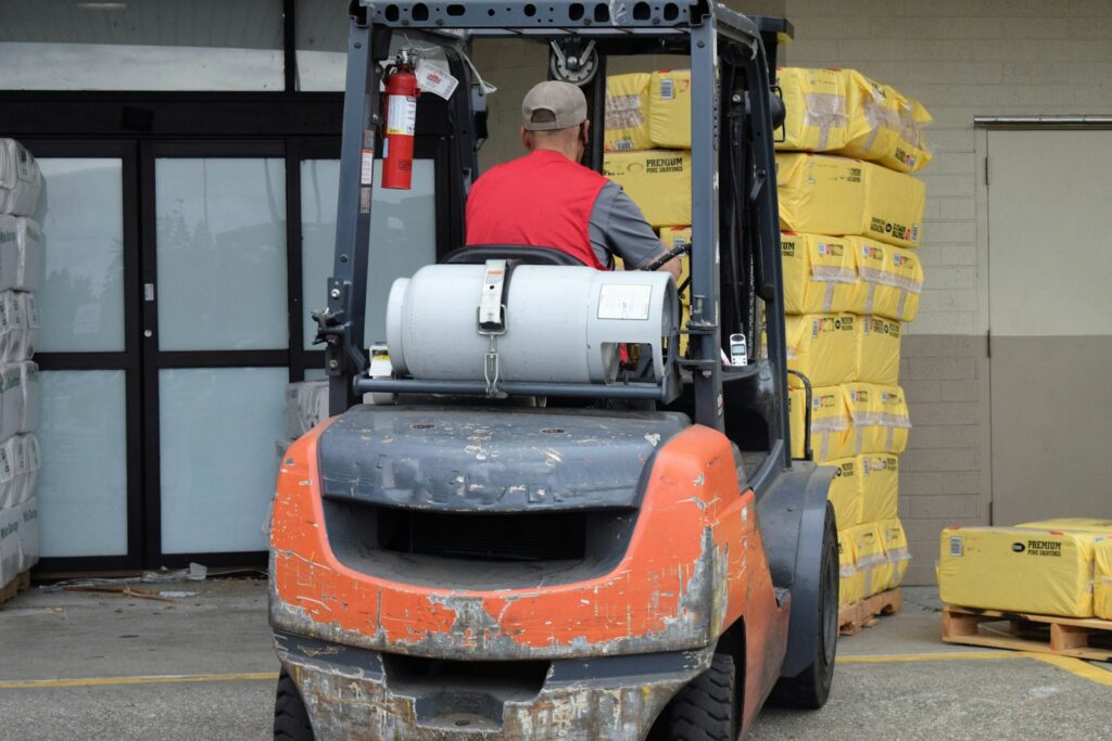 Man driving a forklift in a warehouse, the kind of operator who needs training certification
