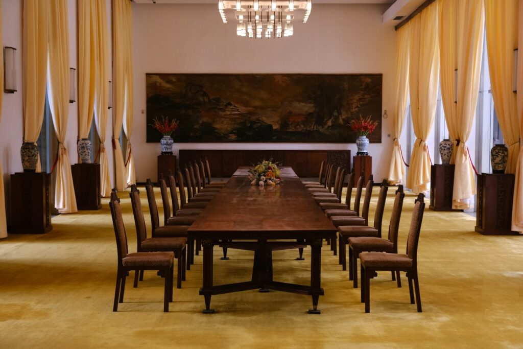 Long wooden table with chairs in a formal room, suited to discussing litigation funding